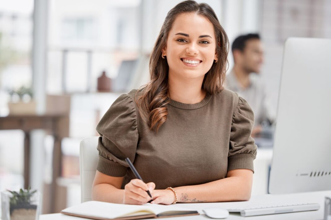 Jeune femme satisfaite de rédiger sa lettre de motivation pour être responsable communication